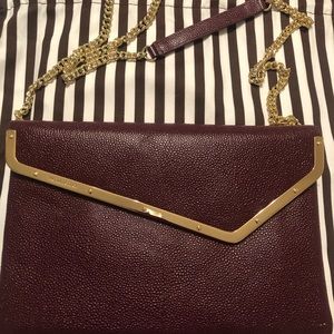 Henri Bendel crossbody/ clutch burgundy purse.
